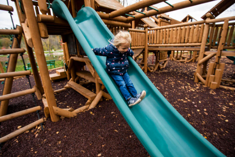 child on the slide in the fall